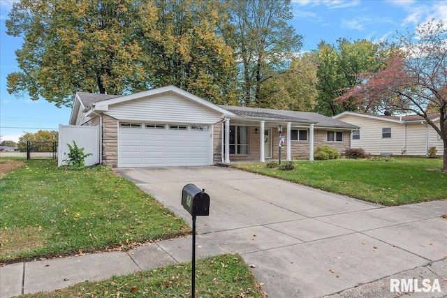 ranch-style home featuring driveway, stone siding, an attached garage, fence, and a front lawn