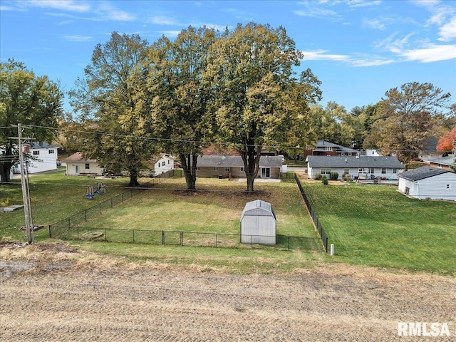 view of yard featuring a barn and fence