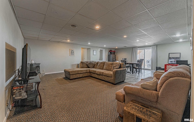 carpeted living room featuring recessed lighting, a wood stove, a drop ceiling, and baseboards