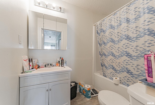 bathroom featuring a textured ceiling, toilet, shower / tub combo, wood finished floors, and vanity