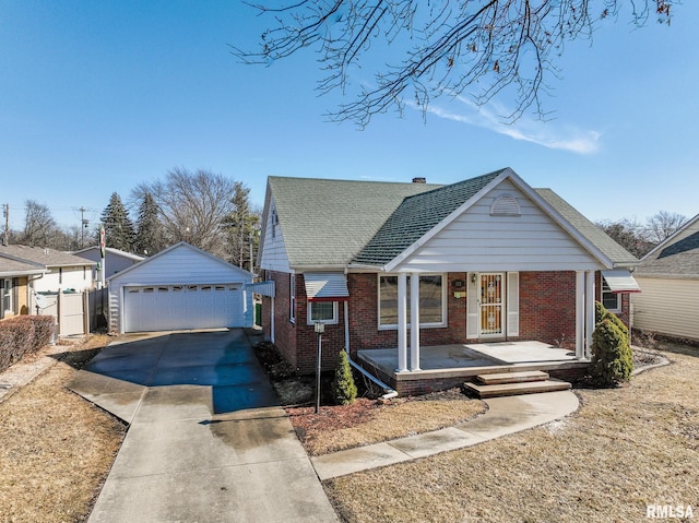 view of front of property with an outbuilding, brick siding, a porch, a shingled roof, and a garage