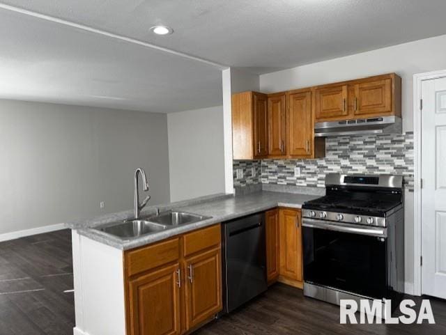 kitchen with dishwasher, gas range, a peninsula, under cabinet range hood, and a sink