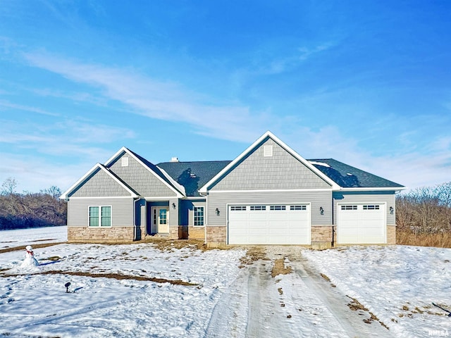 craftsman house with a garage and stone siding