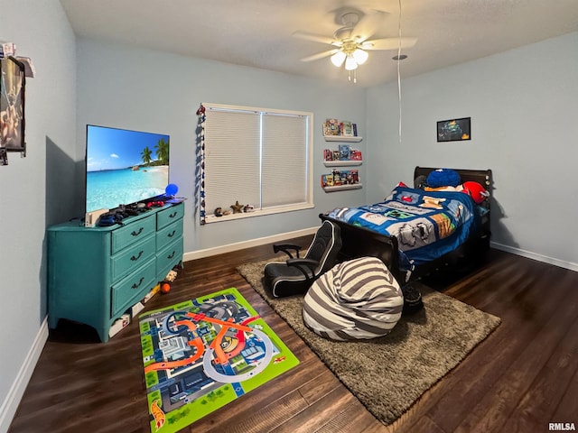 bedroom featuring a ceiling fan, dark wood finished floors, and baseboards