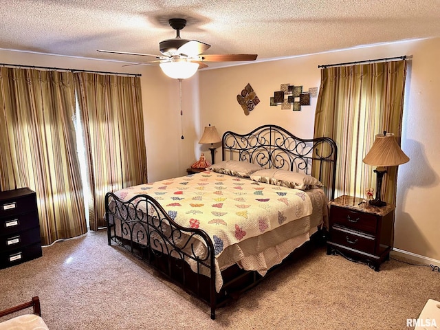 bedroom with a textured ceiling, ceiling fan, and light carpet