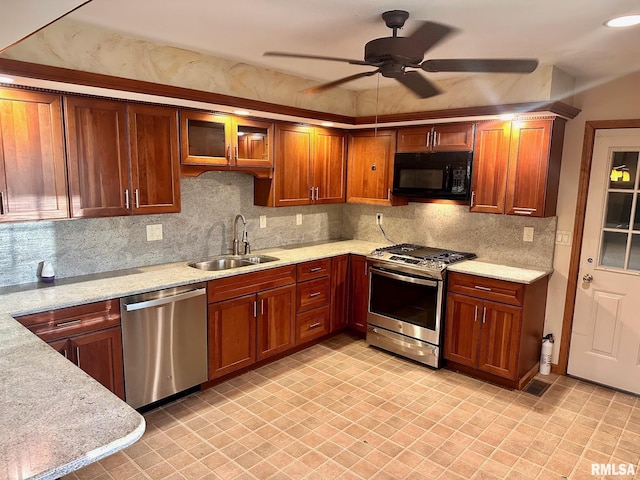 kitchen featuring stainless steel appliances, backsplash, brown cabinetry, a sink, and light stone countertops