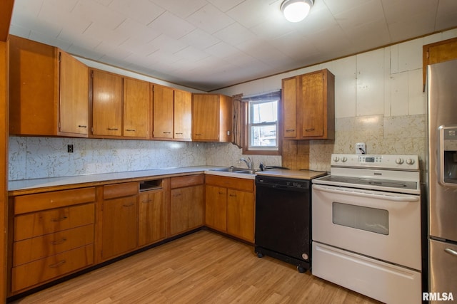 kitchen with brown cabinets, black dishwasher, light countertops, and white electric range oven