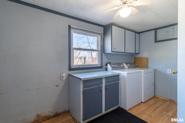 laundry area with light wood finished floors, washing machine and clothes dryer, cabinet space, and a ceiling fan