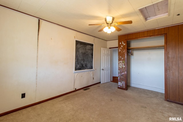 unfurnished bedroom with a ceiling fan, light colored carpet, visible vents, and baseboards