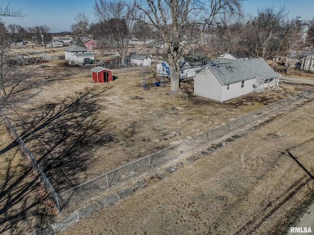 view of yard featuring a storage shed, a fenced backyard, and an outdoor structure