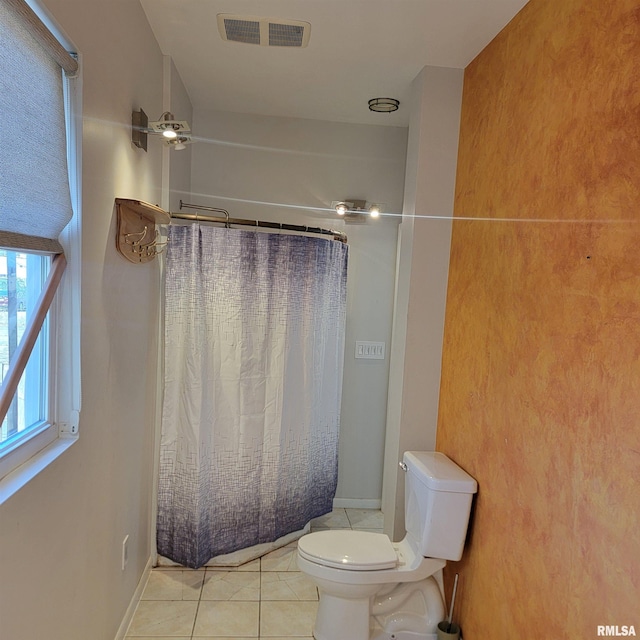 bathroom with baseboards, visible vents, toilet, and tile patterned floors