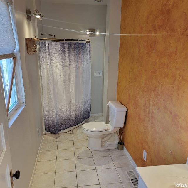 bathroom with baseboards, visible vents, toilet, tile patterned floors, and curtained shower