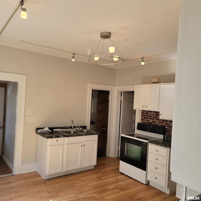 kitchen with light wood-style floors, electric stove, white cabinetry, and hanging light fixtures