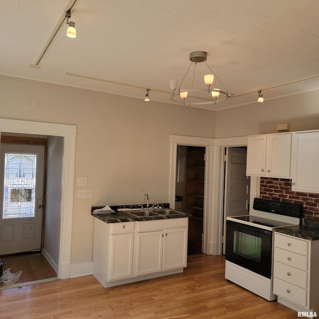 kitchen featuring hanging light fixtures, electric range oven, white cabinetry, a sink, and light wood-type flooring