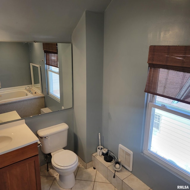 bathroom with toilet, vanity, visible vents, and tile patterned floors