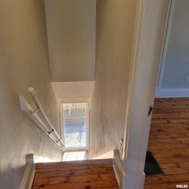 stairway with hardwood / wood-style floors