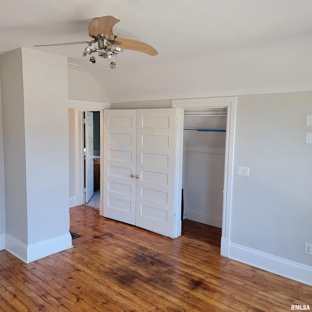 unfurnished bedroom featuring hardwood / wood-style flooring, baseboards, and a closet