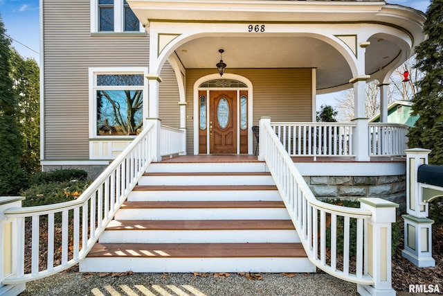 entrance to property featuring covered porch