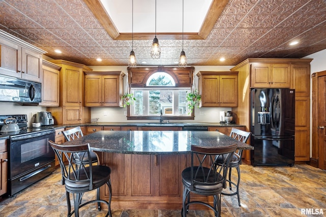 kitchen featuring black appliances, an ornate ceiling, brown cabinetry, and a sink