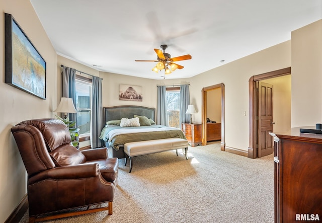 carpeted bedroom featuring a ceiling fan and baseboards