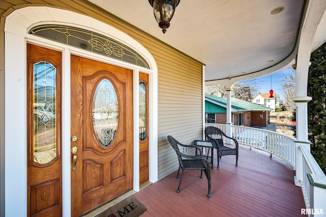 view of exterior entry with covered porch