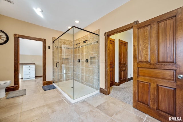 full bath with toilet, a stall shower, visible vents, and tile patterned floors