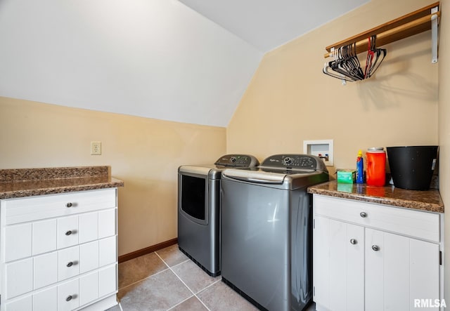 laundry room featuring baseboards, cabinet space, washing machine and clothes dryer, and light tile patterned floors