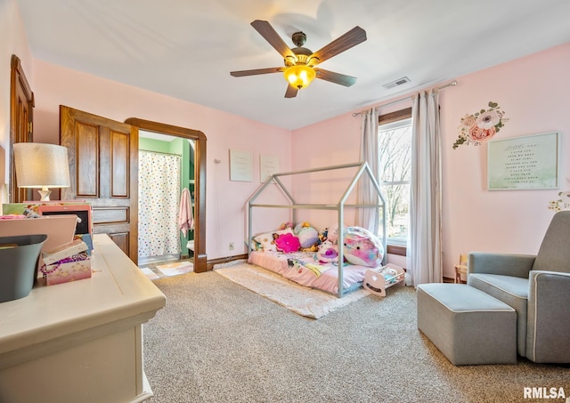 bedroom with ceiling fan, visible vents, and light colored carpet