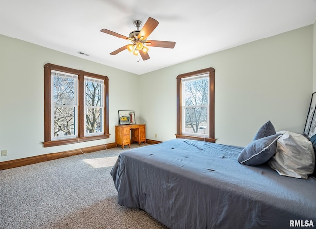 bedroom with carpet floors, baseboards, visible vents, and ceiling fan