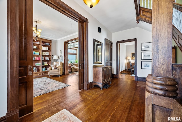 entrance foyer with lofted ceiling, baseboards, dark wood-type flooring, and ornamental molding