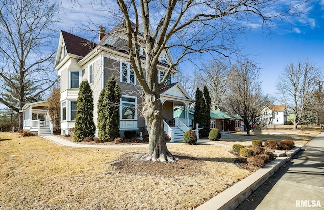 view of front of property with a chimney and a porch