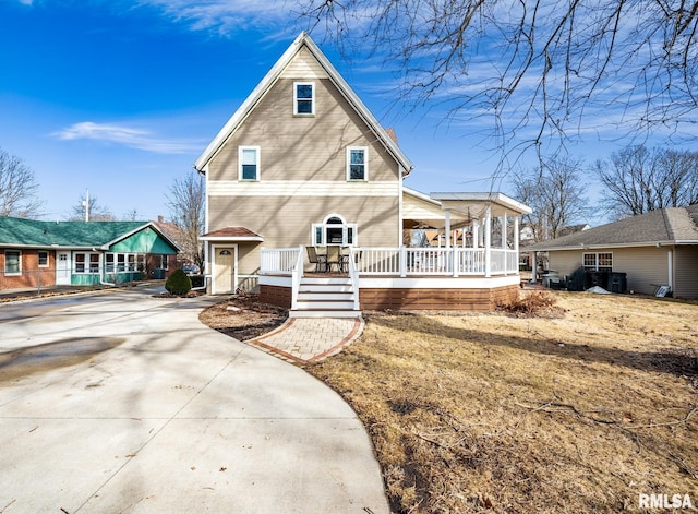 back of property featuring concrete driveway