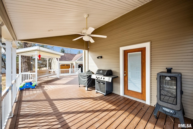 wooden deck with a ceiling fan and area for grilling