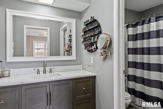 full bath with vanity, curtained shower, and toilet