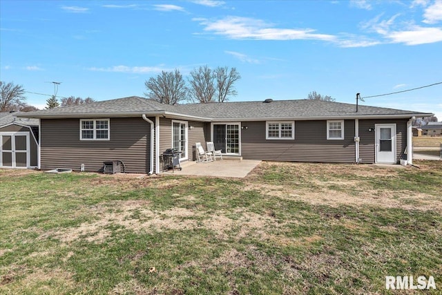 rear view of house featuring a storage unit, an outbuilding, a yard, and a patio area