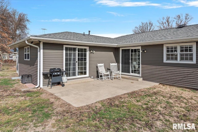 back of property featuring roof with shingles and a patio area