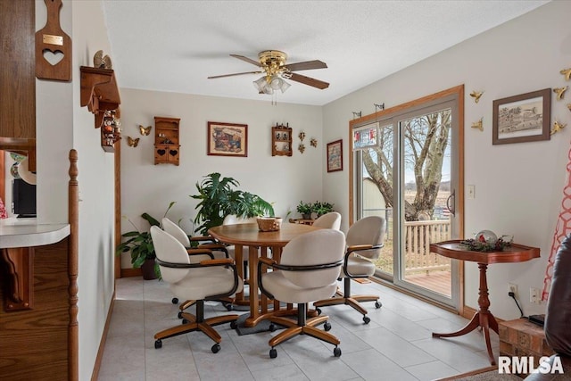 dining space featuring a textured ceiling, ceiling fan, and light tile patterned flooring