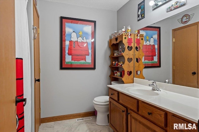 bathroom with a textured ceiling, toilet, visible vents, vanity, and baseboards