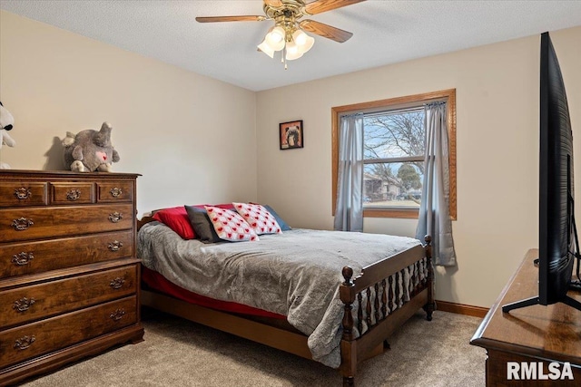 bedroom with a ceiling fan, light colored carpet, a textured ceiling, and baseboards