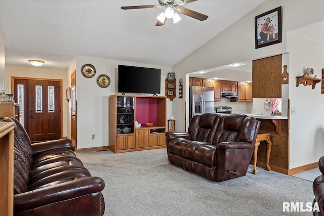 living area with high vaulted ceiling, ceiling fan, baseboards, and light colored carpet