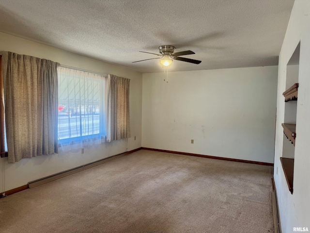 empty room featuring a textured ceiling, a baseboard radiator, a ceiling fan, baseboards, and carpet