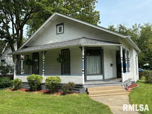 view of front of house with a porch, crawl space, a shingled roof, and a front lawn