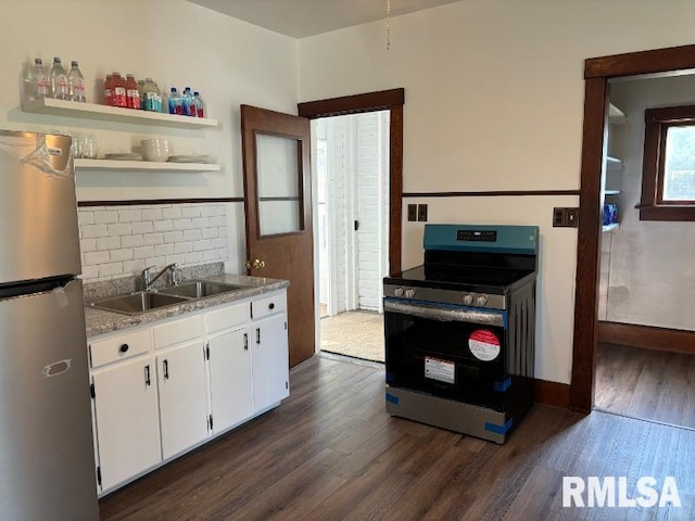 kitchen featuring dark wood finished floors, stainless steel appliances, white cabinetry, open shelves, and a sink