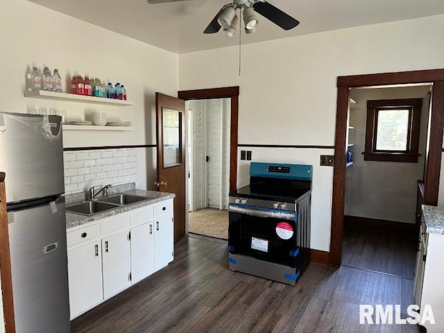 kitchen featuring open shelves, appliances with stainless steel finishes, dark wood-type flooring, and a sink