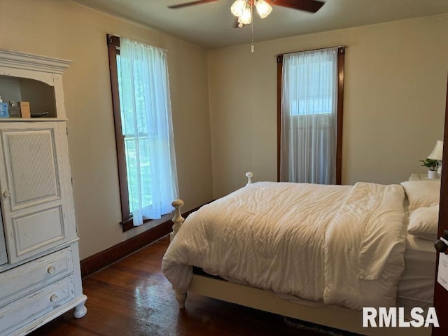 bedroom with a ceiling fan, baseboards, and wood finished floors