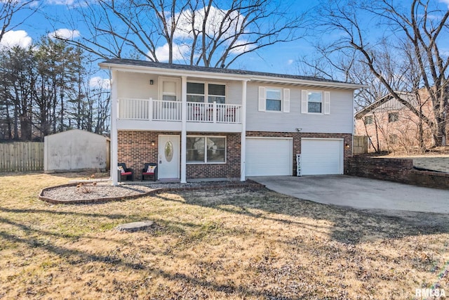 view of front of home featuring brick siding, fence, concrete driveway, a garage, and a balcony