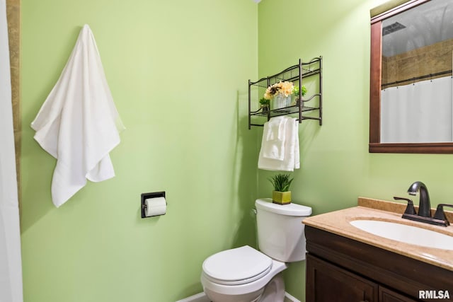 full bathroom with vanity, curtained shower, and toilet