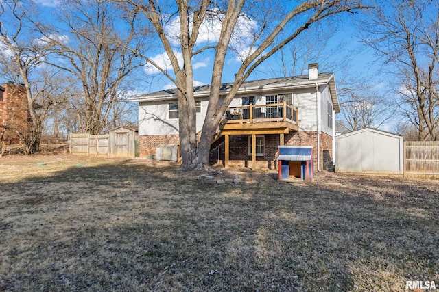 back of property featuring brick siding, a wooden deck, a storage unit, and an outdoor structure