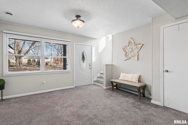 sitting room featuring visible vents, a textured ceiling, carpet flooring, and stairway