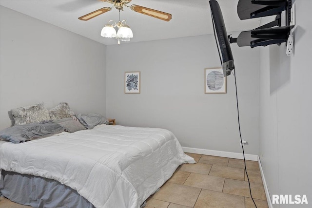 bedroom featuring tile patterned flooring, a ceiling fan, and baseboards